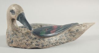 A PAINTED WOOD DECOY DUCK.