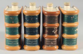 A SET OF FOUR FRENCH POTTERY BOOK FORM LIQUOR BOTTLES.