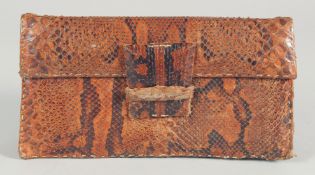 A 1940's - 1950's SNAKESKIN PURSE with fold over front. 9.5ins long, 5ins deep.