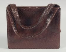 A 1940's - 1950's BROWN SNAKESKIN HANDBAG with fitted leather interior and two handles. 7.5ins deep,
