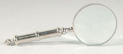 A MAGNIFYING GLASS with chrome handle.