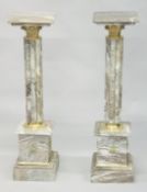 A PAIR OF MARBLE COLUMNS with ormolu mounts. 3ft 3ins high.