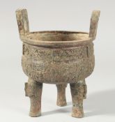 A GOOD ARCHAIC BRONZE CENSER on three legs. 6ins diameter.