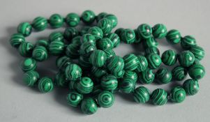 A STRING OF MALACHITE BEADS.