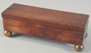 AN EARLY PIQUET BOX with sliding lid on four ball feet.