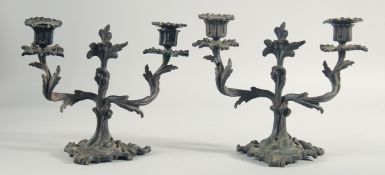 A PAIR OF 19TH CENTURY BRONZE TWO BRANCH CANDLESTICKS. 8.5ins high.