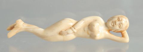 A CARVED BONE DOCTOR'S NUDE FIGURE.