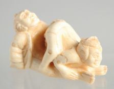 A CARVED BONE EROTIC NETSUKE. 2ins.