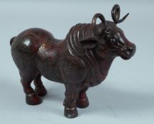A CHINESE BRONZE STANDING BULL 9ins long.