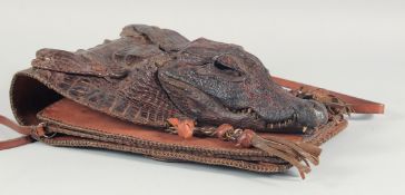 A RARE ALLIGATOR SKIN BROWN HANDBAG with two handles, the flap with a small head and two pairs of
