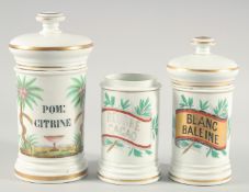THREE EARLY PORCELAIN DRUG JARS of various sizes, with two lids. 10ins, 8ins & 6ins high.
