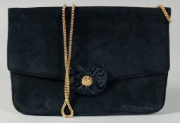 A BLACK VELVET EVENING BAG with gilt handles and cluster clasp. 9ins long, 6ins deep.