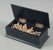 A BOX OF PRE HISTORIC SHARK TEETH.