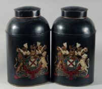 A PAIR OF CRESTED TOLEWARE TEA TINS AND COVERS. 17ins high.