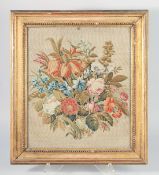 A GOOD 19TH CENTURY BRUSSELS NEEDLEWORK OF ARRAY OF FLOWERS. 12ins x 14ins framed and glazed.