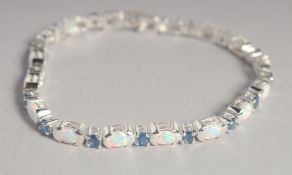 A SILVER SAPPHIRE AND OPAL LINE BRACELET.