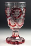 A GOOD CONTINENTAL RUBY TINTED GLASS engraved with panels of flowers. 6ins high.