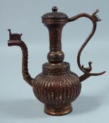 AN ISLAMIC BRONZE EWER. 9ins high.