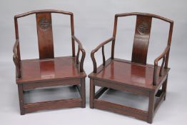 A PAIR OF CHINESE REDWOOD ARMCHAIRS.