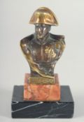 A SMALL BRONZE BUST OF NAPOLEON, stamped Waterloo, on a marble plinth. 3ins high.