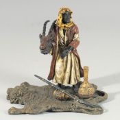 A VIENNA PAINTED COLD CAST BRONZE GROUP, a man holding a deer's head. 5ins high.