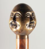 A WALKING STICK with bronze Buddha’s head.