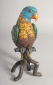 A LARGE COLD PAINTED BRONZE PARROT on a branch. 11ins high.