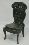 A JAPANESE HALL CHAIR with curved decoration, depicting a tiger beneath a tree.
