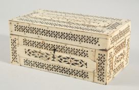 A NAPOLEONIC CARVED AND PIERCED BONE CASKET. 8ins long, 4.5ins wide, 3ins high.