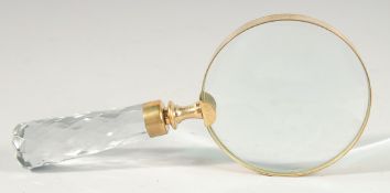 A MAGNIFYING GLASS with cut glass handle.