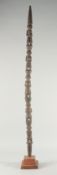 A LONG CARVED AND PAINTED WOODEN TRIBAL STAFF. 4ft long.
