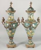 A LARGE PAIR OF LOUIS XVI STYLE PORCELAIN AND ORMOLU URN SHAPED VAES AND COVERS painted with