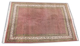 A PERSIAN DESIGN CARPET, pink ground with all over 