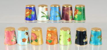 A SET OF 12 CLOISONNE ENAMEL THIMBLES.