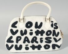 A USED LOUIS VUITTON, PARIS, BLACK AND WHITE HANDBAG. 11ins long, 7 ins deep.