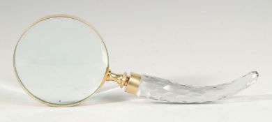 A MAGNIFYING GLASS with cut glass handle.