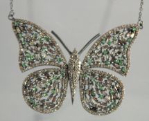 A DIAMOND SET BUTTERFLY PENDANT AND CHAIN.