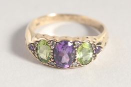 A 9CT GOLD AMETHYST, PERIDOT AND DIAMOND RING.