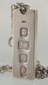 A SILVER MARKS TABLET AND CHAIN.