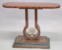 AN ART DECO STYLE CONSOLE TABLE with a rounded rectangular top, shaped support, cast metal