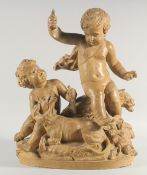 A GOOD 19TH CENTURY TERRACOTTA GROUP OF TWO CHERUBS with a dog and dead game on an oval base.