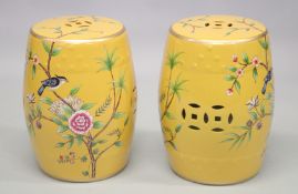 A PAIR OF CHINESE STYLE BARREL SEATS decorated with birds on a branch. 1ft 5ins high.