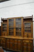 A GOOD VICTORIAN AESTHETIC MOVEMENT OAK BREAK FRONT LIBRARY CUPBOARD BOOKCASE with ornate brass