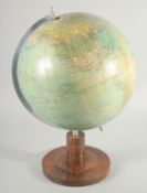 A GERMAN GLOBE OF THE WORLD BY POLITIS ERD GLOBUS. 12ins diameter on a wooden base.