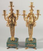A PAIR OF EMPIRE DESIGN GILT BRONZE CANDELABRA, a figure holding three scones. 17.5