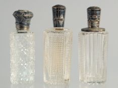 THREE SILVER TOP GLASS SCENT BOTTLES.