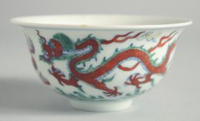 A SMALL CHINESE PORCELAIN CIRCULAR BOWL decorated with a dragon. 4.4ins diameter.