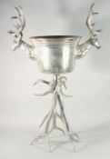 A LARGE SILVER PLATED STAG WINE COOLER on stand. 41ins high.
