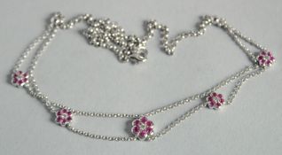 A 18CT GOLD RUBY AND DIAMOND CLUSTER NECKLACE.