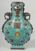 A CHINESE CLOISONNE ENAMEL MOON VASE with elephant handles and calligraphy. 14ins high.